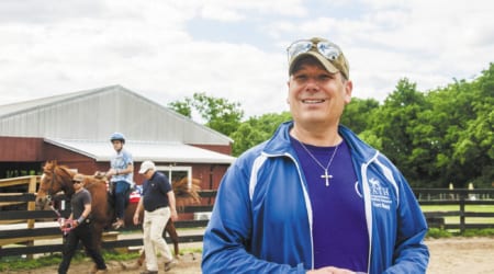 Curt Stacy, director of the Therapeutic Equine Assistance Method program in Nashville, Tenn., is seen on the grounds of First Presbyterian Church in Oak Hill, Tenn., May 13, 2019. The program, run by Stacy, a Catholic, is an ecumenical outreach ministry to serve adults who have disabilities and and also to help veterans. (CNS photo/Theresa Laurence, Tennessee Register) See RIDING-THERAPEUTIC-DISABLED July 1, 2019.