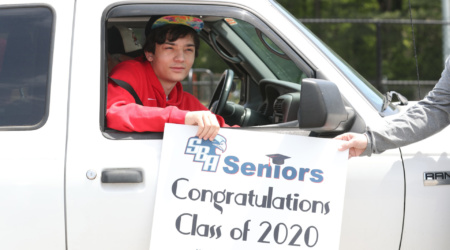 DANIEL CHADWICK, SBA Senior pulls up to get his cap and gown. Memphis high school seniors, who are in on-line classes,  received their graduation supplies Friday April 17, 2020 in drive through, socially distanced fashion. Administrators from Saint Benedict at Auburndale High School in Memphis, Tennessee distributed senior caps, gowns, graduation invitations and Congratulation Seniors Yard Signs in the school's parking lot.