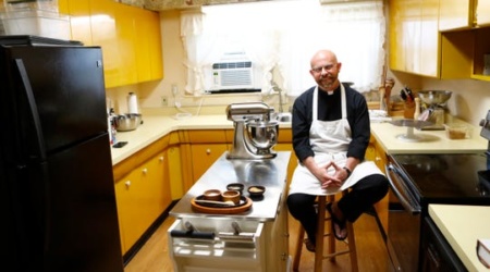 Father Ben Bradshaw of St. Michael Catholic Church sits in the church's kitchen on Monday, April 6, 2020. Bradshaw, a classically trained chef, has been hosting a cooking show for years called "Soul Food Priest," which has taken on new meaning in the last few weeks as a way to connect with parishioners during a time when in-person church services have been canceled. (Photo: Joe Rondone/The Commercial Appeal)