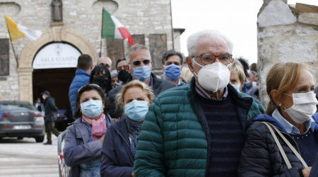 People wait outside the Basilica of St. Francis as Pope Francis celebrates Mass in Assisi, Italy, Oct. 3, 2020. The pope was to sign his new encyclical, "Fratelli Tutti, on Fraternity and Social Friendship," near the tomb of St. Francis. (CNS photo/Paul Haring)