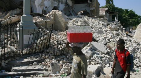 People walk past the destroyed Sacred Heart Church in 2010 in Port-au-Prince, Haiti. Jan. 12 marked the eighth anniversary of the magnitude 7.1 magnitude earthquake that rocked the Caribbean nation. (CNS photo/Bob Roller)